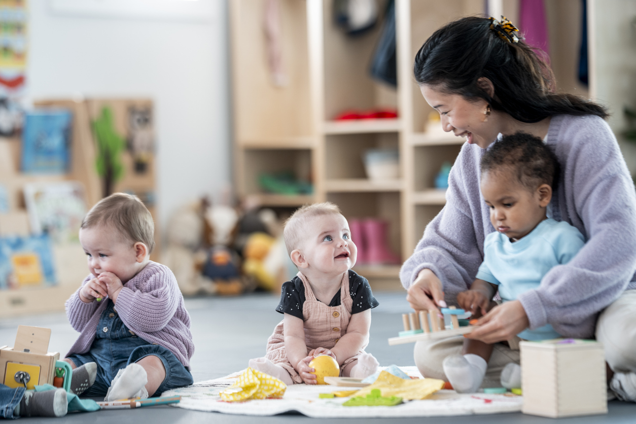 Caretaker Engages with Infants and Children in Early Education Environment